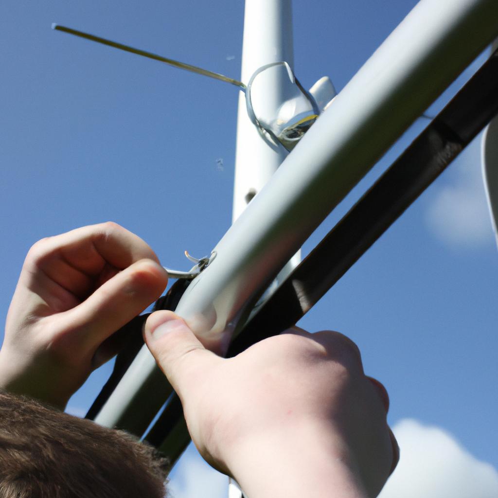 Person adjusting radio antenna outdoors